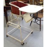 A 'vintage' white painted metal metamorphic nursery highchair, on 'big-wheel' castors