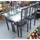 A modern dining table, the glass top on a steel frame and square legs  31"h  59"w  35"deep; and a