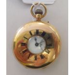 An 18ct gold half hunter pocket watch, the keyless movement faced by an enamelled Roman dial with