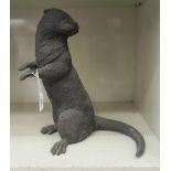 A patinated cast metal garden ornament, an otter  14"h