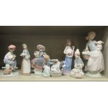 Seven various Lladro porcelain figures: to include a girl carrying a basket of produce and a lamb
