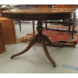 A Regency design, faux drum top mahogany dining table, comprising a pair of D-ends, raised on a