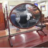 An Edwardian satinwood and ebony inlaid mahogany dressing table mirror, the oval plate pivoting on