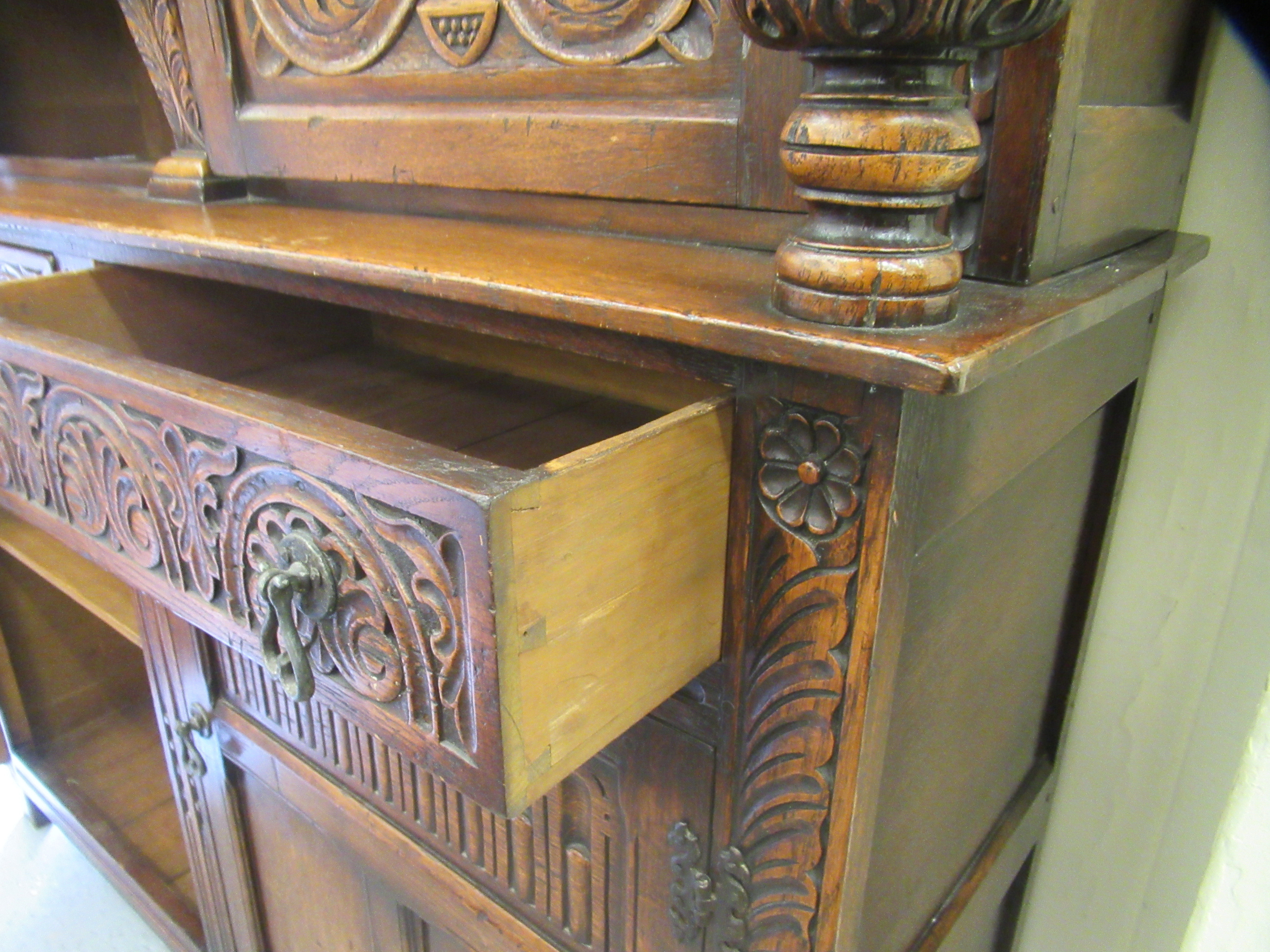 A 1920s/30s carved oak court cupboard, the frieze drawer over a pair of recessed doors and outset - Image 4 of 4