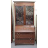An Edwardian and string inlaid mahogany bureau bookcase with an astragal glazed and shelved upper