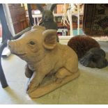 Composition garden ornaments: to include a seated piglet  10"h