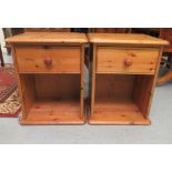 A pair of modern honey coloured pine bedside cupboards, each with a short drawers, over an open