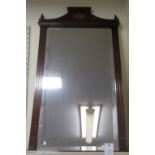 An Edwardian style mirror, the bevelled plate set in a mahogany frame with a platform crest  27" x