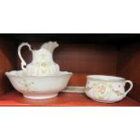 A late Victorian Devonware china wash jug, bowl and chamber pot, decorated with swags and