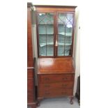 A 1930s mahogany bureau bookcase, the upper section having two astragal glazed doors with a fall