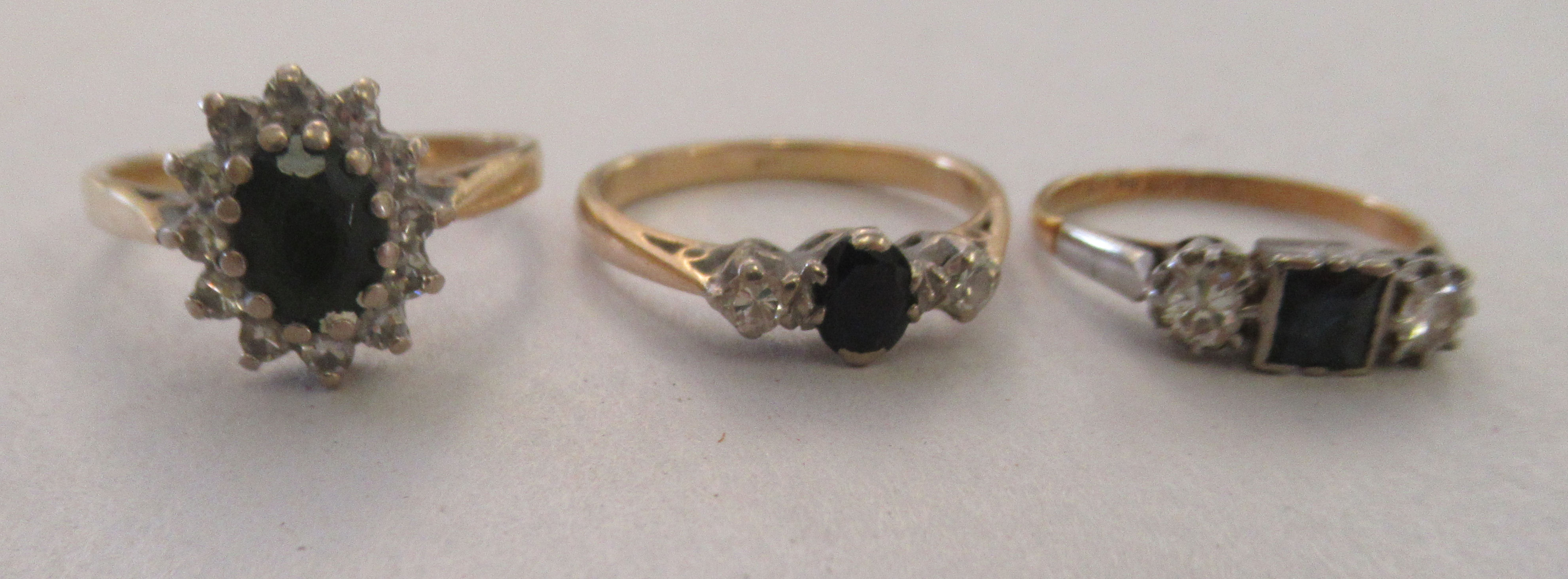 Three 18ct gold rings, each set with an arrangement of sapphires and diamonds