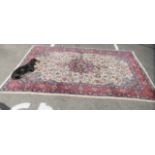 An Iranian Sarouk carpet with dense floral decoration on a red and blue ground  82" x 128"