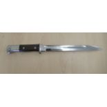 A German World War I Imperial S84/98 saw-back bayonet with a riveted, two part wooden handgrip,