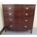An early 19thC mahogany bow front dressing chest with two short/three graduated long drawers, raised