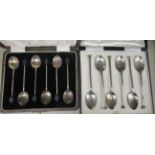 A set of six silver seal terminal coffee spoons  cased; and a set of six bean end coffee spoons