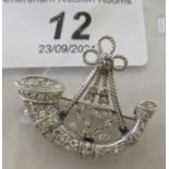 A white metal brooch, featuring the badge of 52 (Oxfordshire) Regiment of Foot, fashioned as a