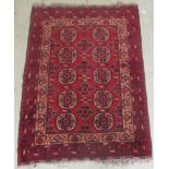 A Bokhara rug, decorated with two columns of five octagonal guls, on a red ground  45'' x 56''