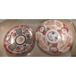 Two 19thC Japanese Imari porcelain chargers, decorated in colours with flora and foliage  16" & 19"