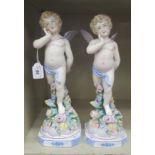 A pair of 20thC Continental standing porcelain figures, each Cupid with a bow and a quiver of