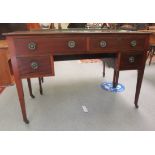 An Edwardian satinwood inlaid mahogany desk with two short/two long drawers, raised on square,