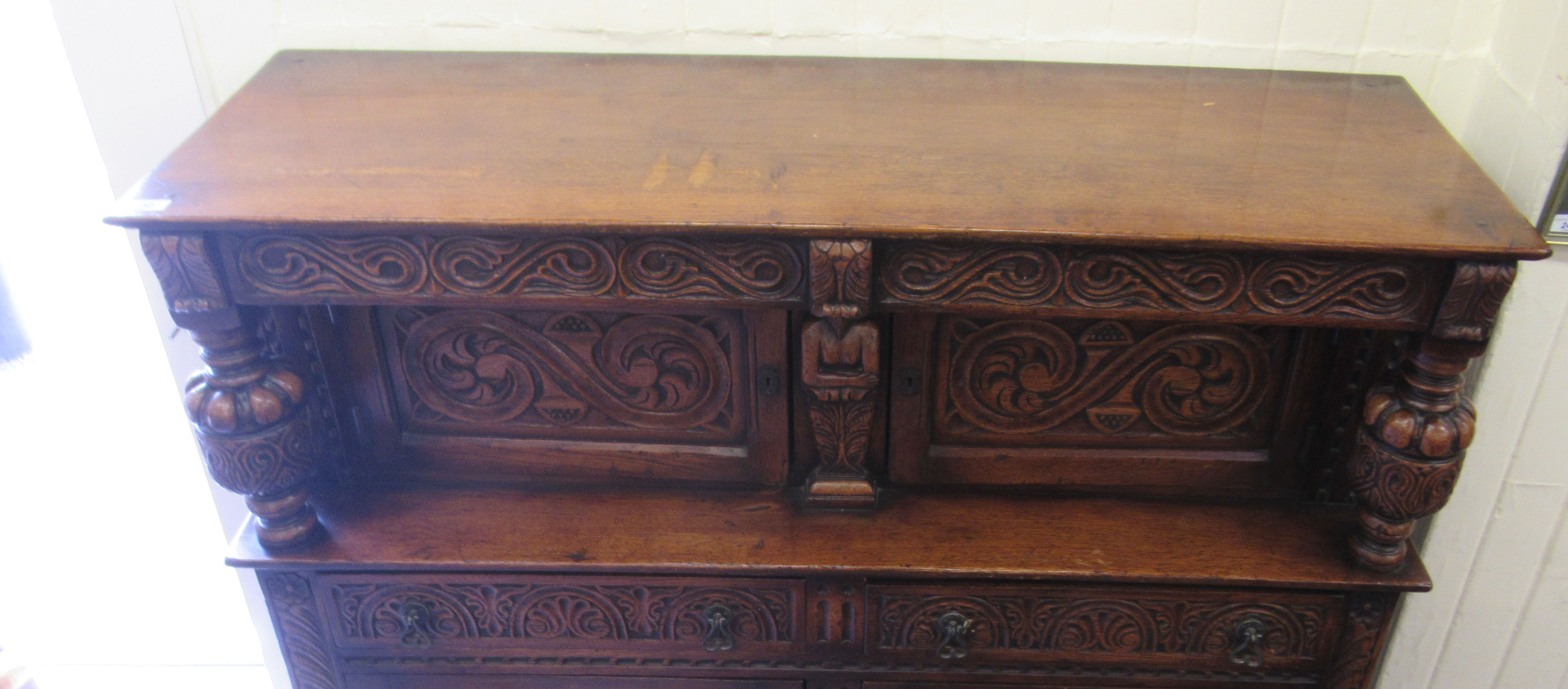 A 1920s/30s carved oak court cupboard, the frieze drawer over a pair of recessed doors and outset - Image 2 of 4