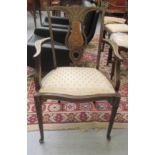 An Edwardian mahogany framed bone and marquetry salon chair with a shield shape back and upholstered