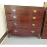 An early 19thC mahogany bow front dressing chest with two short/three graduated long drawers, raised