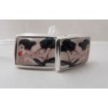 A pair of silver and painted enamel cufflinks, each featuring an erotic portrait