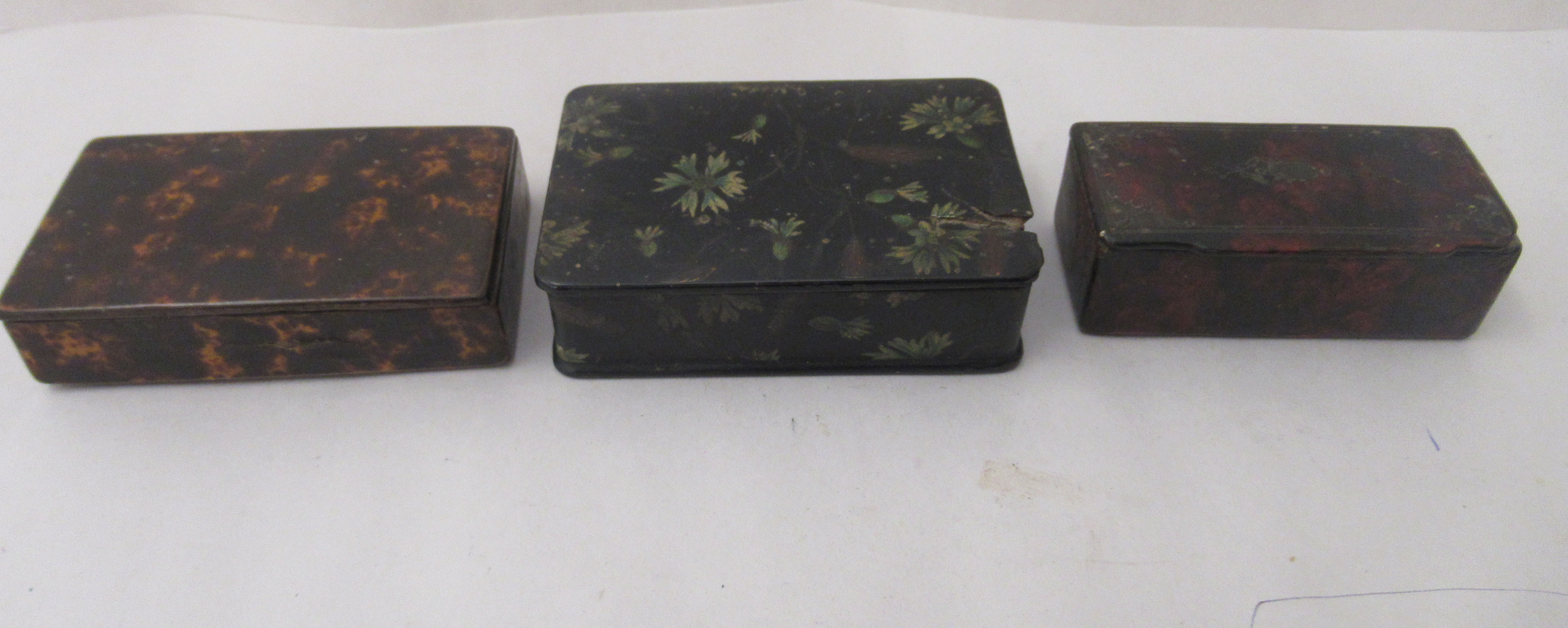 Three similar 19thC painted papier mache snuff boxes of rectangular form with hinged lids