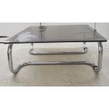 A modern chromium plated occasional table of tubular design with a tinted glass top  11.5"h  26"w