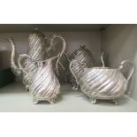 A late Victorian silver plated four piece tea set with spiral reeded floral decoration