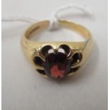 An 18ct gold gypsy design ring set with a garnet