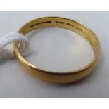 A gold coloured metal wedding ring