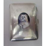 A silver cushion moulded cigarette case, featuring an enamelled portrait of a dog  Birmingham 1918
