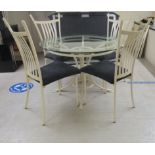 A modern cream painted metal table with a glass top, raised on splayed legs  30"h  43"dia; and a set