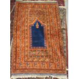 A Persian prayer rug, on a burnt orange coloured ground  36" x 60"