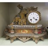 A late 19thC French gilded metal and Spelter cased mantel clock, featuring a seated man, on an