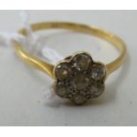 An 18ct gold daisy design, diamond set ring