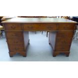 A modern walnut finished nine drawer, twin pedestal desk, raised on bracket feet  31"h  55"w