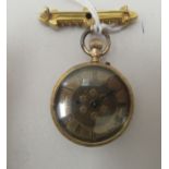 A ladies late 19thC 14ct gold cased fob watch, faced by a Roman dial, on a 15ct gold clasp