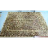 A Persian design rug with floral motifs, on a brown ground  110" x 136"