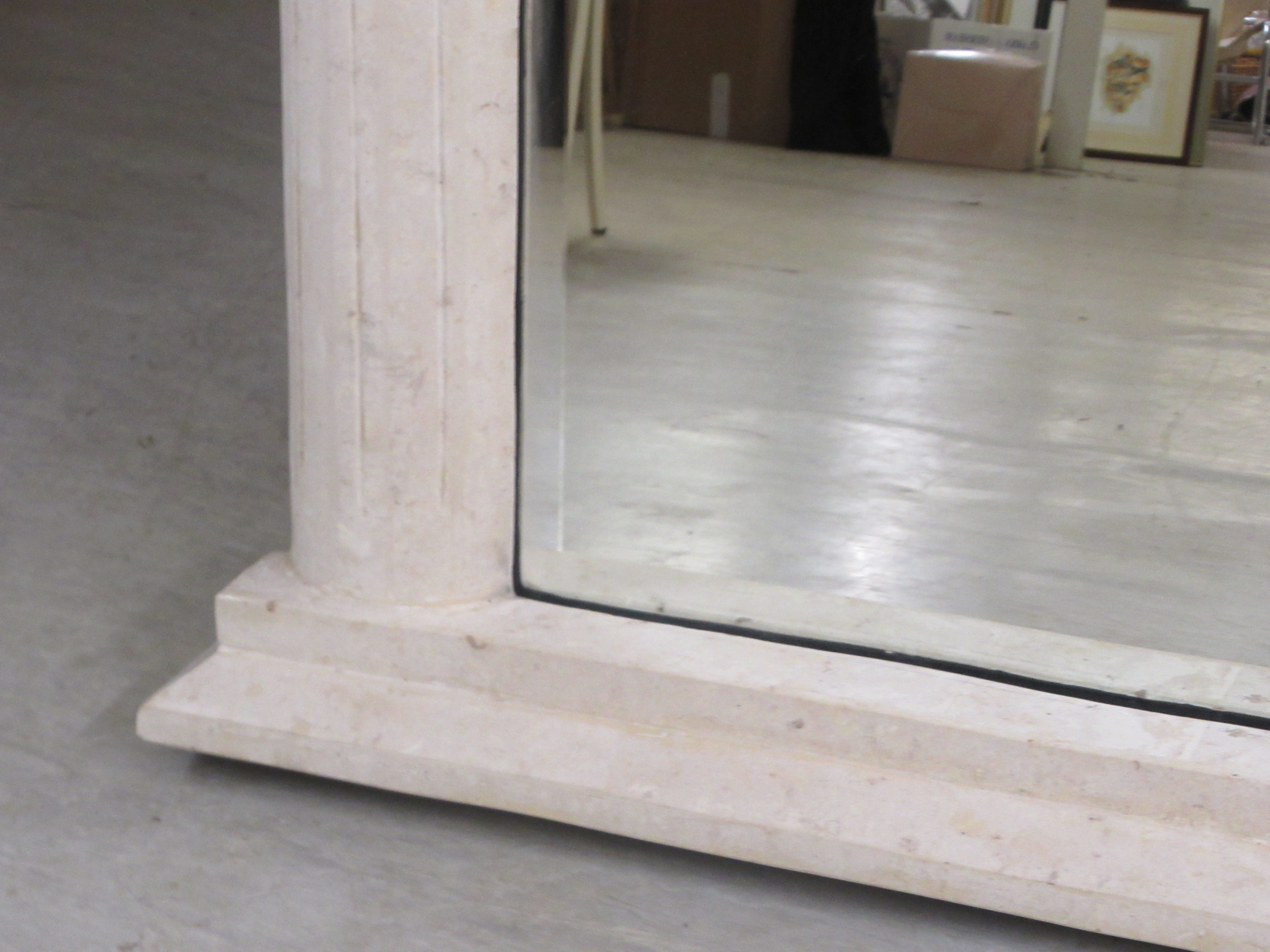 A modern overmantel mirror, the bevelled plate set in a weathered stone effect composition framed - Image 3 of 4
