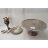 A silver miniature salver; a silver wine goblet; two silver napkin rings; and a silver plated