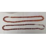 Two amber coloured oval and round bead necklaces