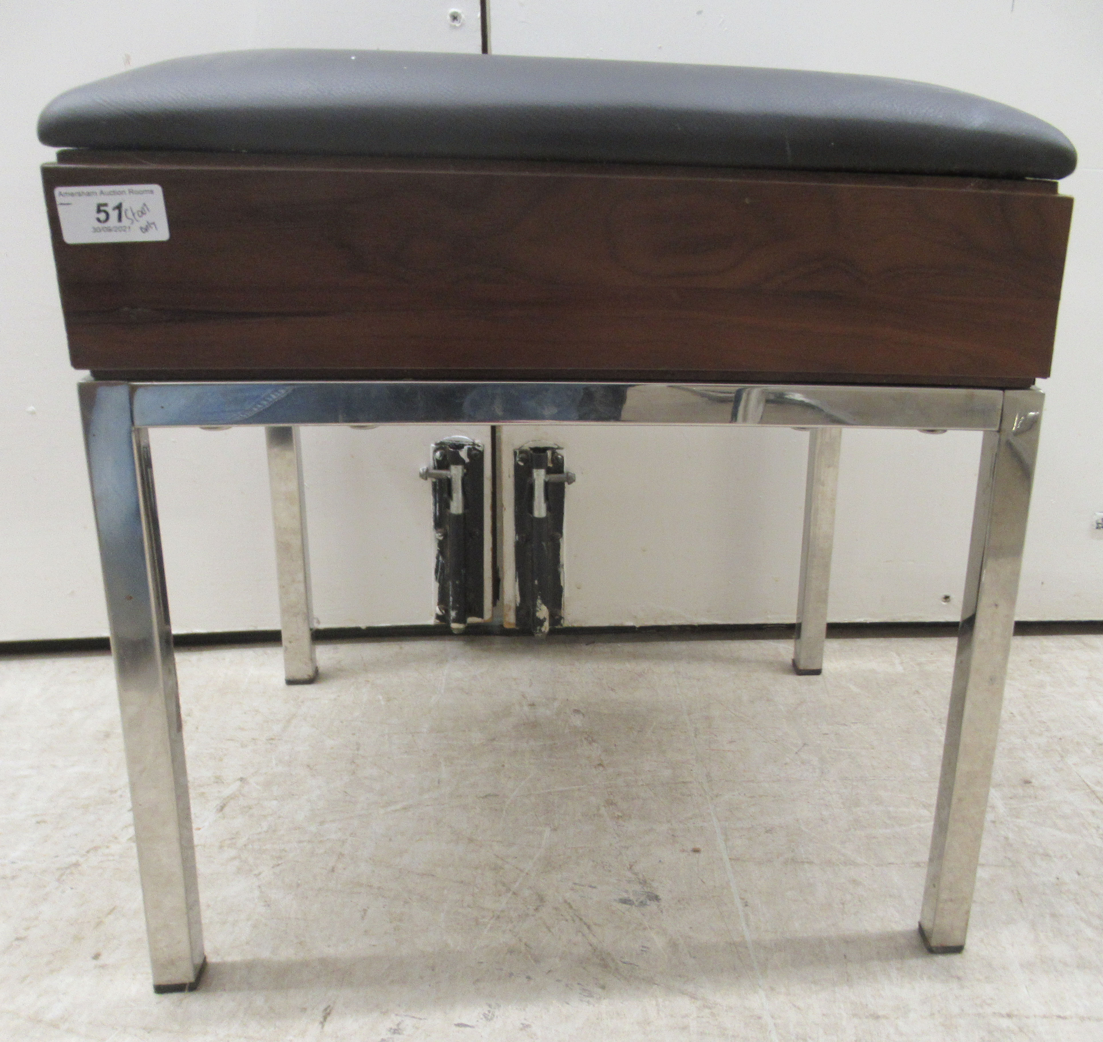 A modern Bentley Design UK stool, the cushioned black vinyl seat over a teak finished panel,