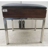 A modern Bentley Design UK stool, the cushioned black vinyl seat over a teak finished panel,