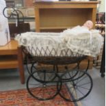A wrought metal and wicker dolls pram; and an Alberon doll with porcelain head and painted