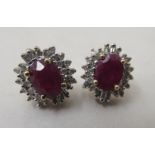 A pair of 14ct gold ruby and diamond set cluster earrings