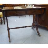 A 20thC reproduction of a Georgian string inlaid walnut finished sofa table with two frieze