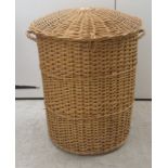 A wicker laundry basket  25"h  30"dia